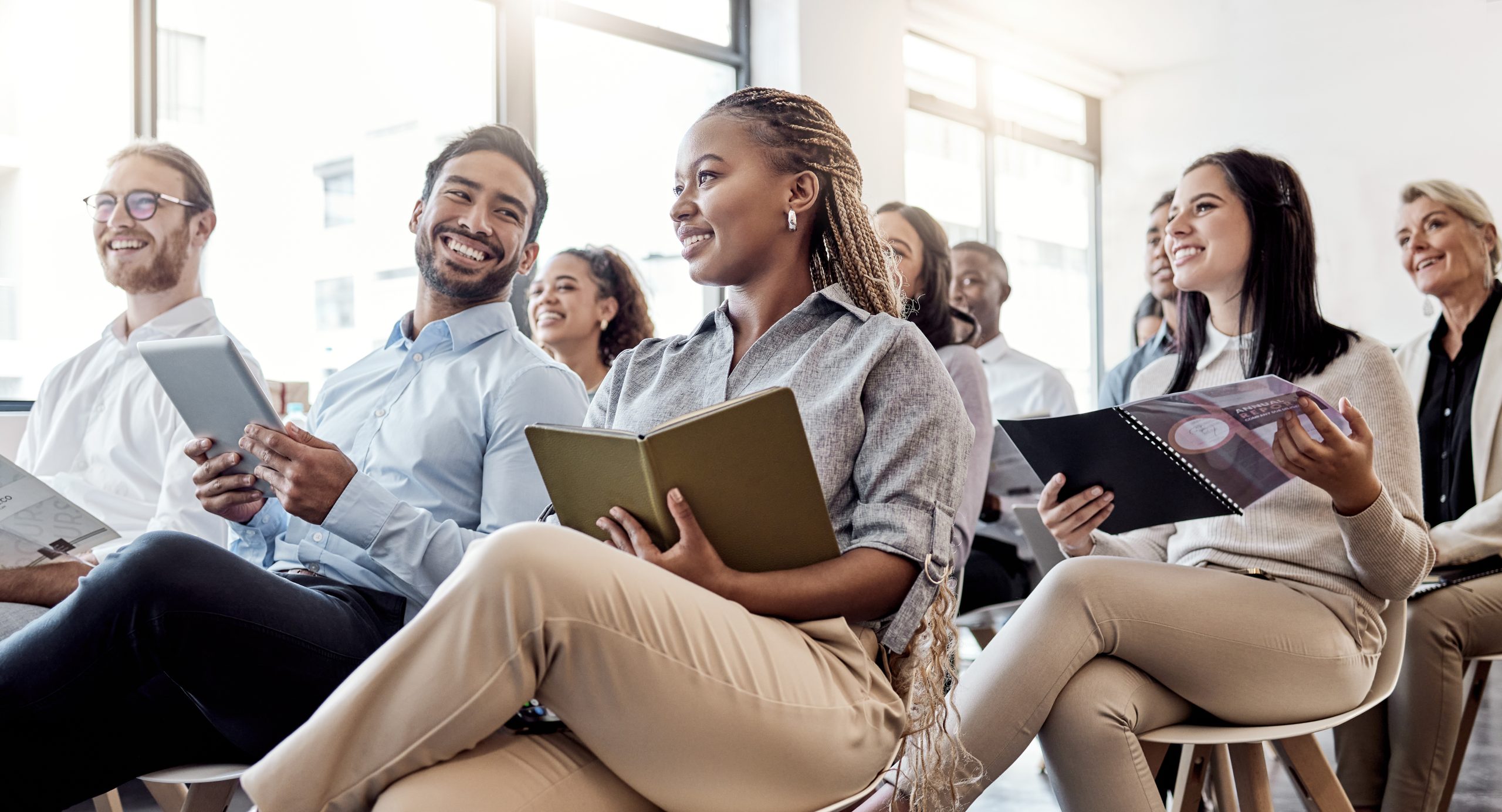 Teamwork, conference and business people with notebook in office for career workshop, training and seminar. Presentation, corporate and audience writing notes for discussion, meeting and convention